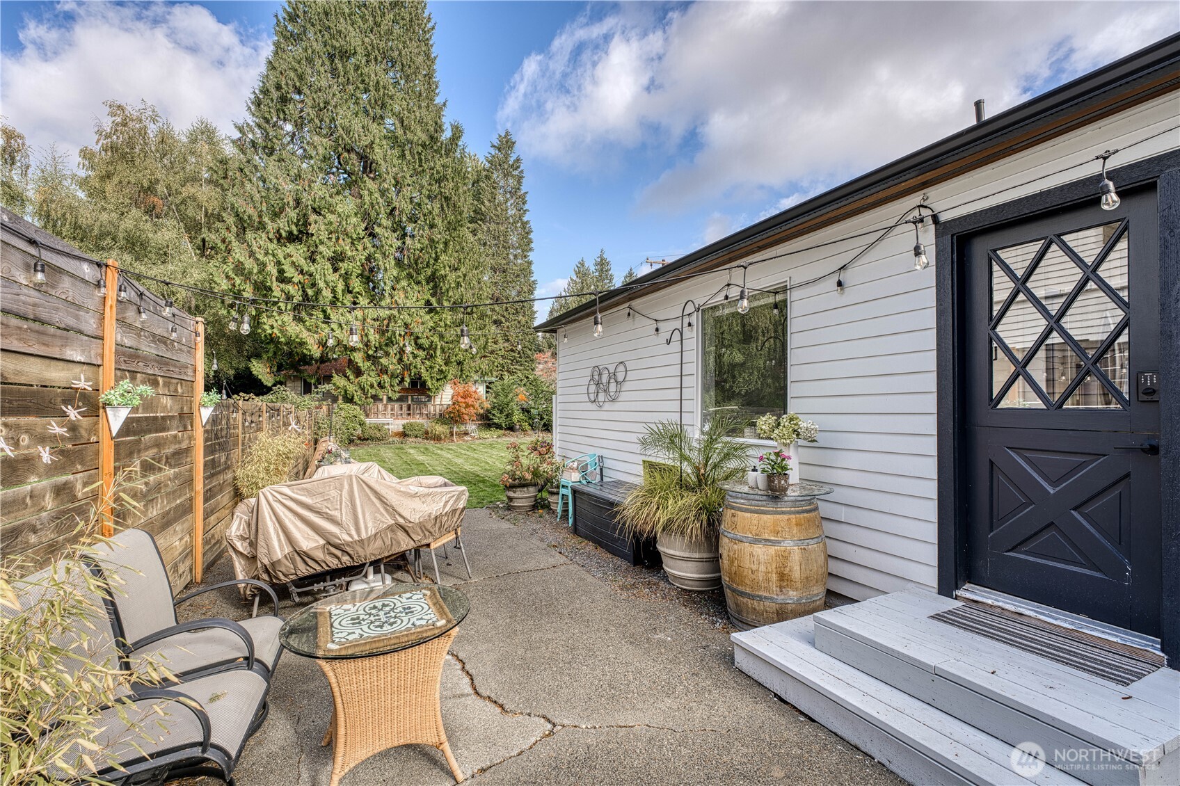 10536 Northeast 189th Street Bothell, WA 98011 - Photo 27 of 37 a view of a patio with couple of chairs and potted plants
