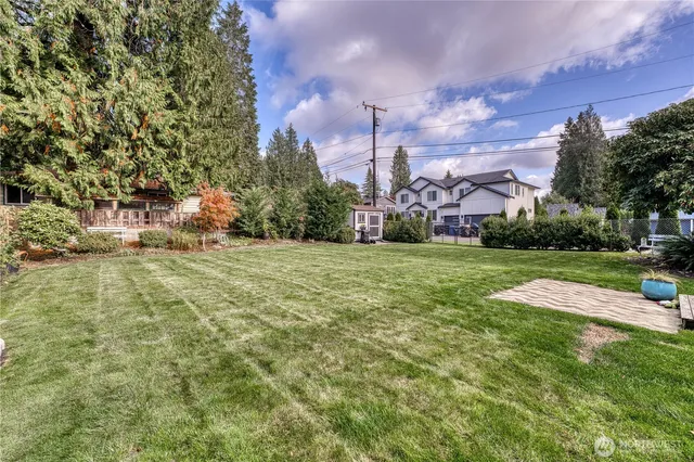 a view of a park with a house in the background