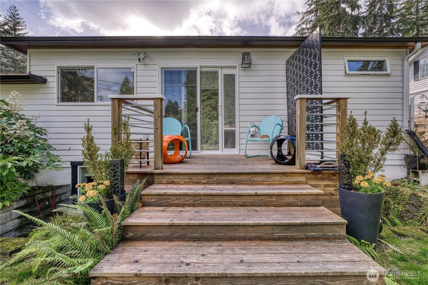 10536 Northeast 189th Street Bothell, WA 98011 - Photo 31 of 37 a view of a house with large windows and plants