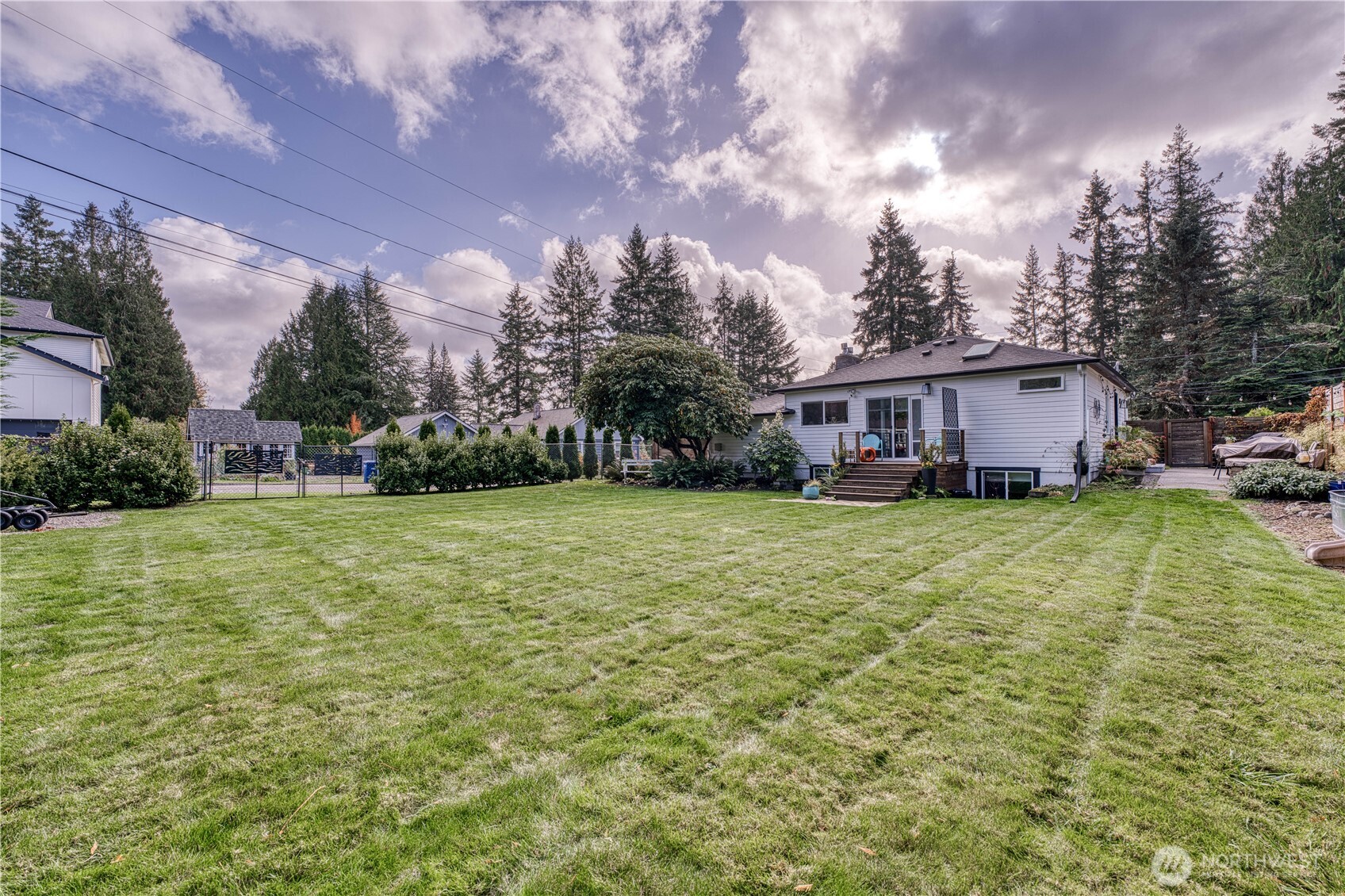10536 Northeast 189th Street Bothell, WA 98011 - Photo 33 of 37 a view of a house with a big yard and large trees
