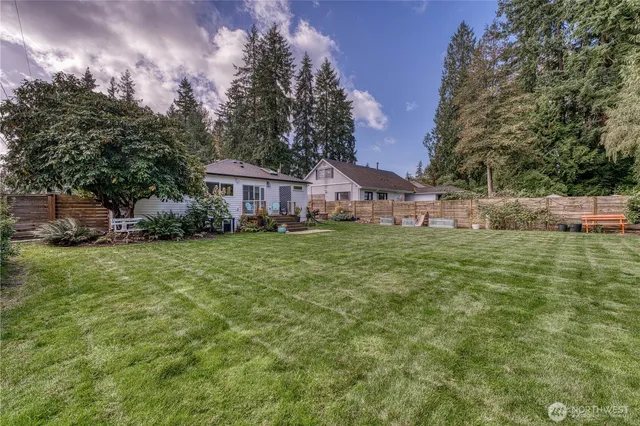 a view of a house with a yard and sitting area