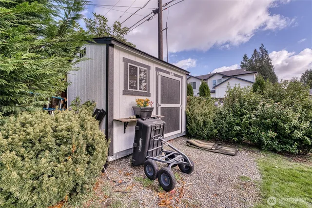 a view of a chair and table in the backyard