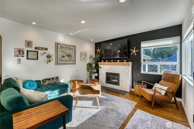 a living room with furniture a fireplace and a flat screen tv