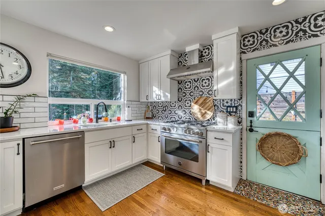 a kitchen with stainless steel appliances granite countertop a stove and a sink