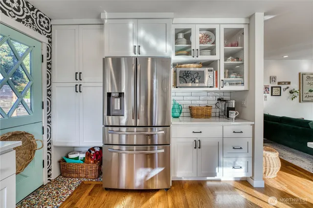 a kitchen with stainless steel appliances a refrigerator sink and cabinets
