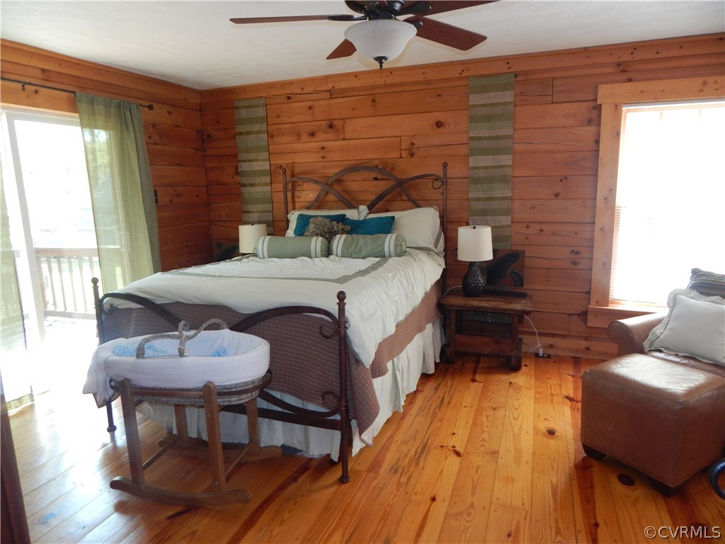 1451 Mill Road Henrico, VA 23231 - Photo 7 of 23 a spacious bedroom with a bed and a chair