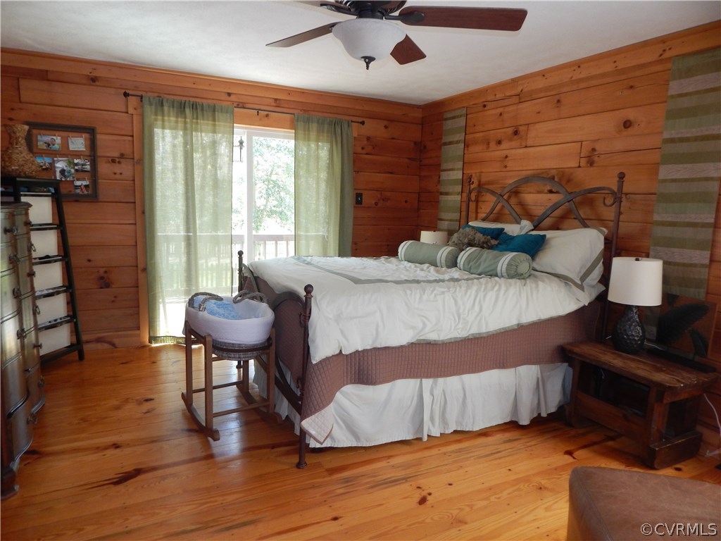 1451 Mill Road Henrico, VA 23231 - Photo 8 of 23 a bedroom with a bed and wooden floor
