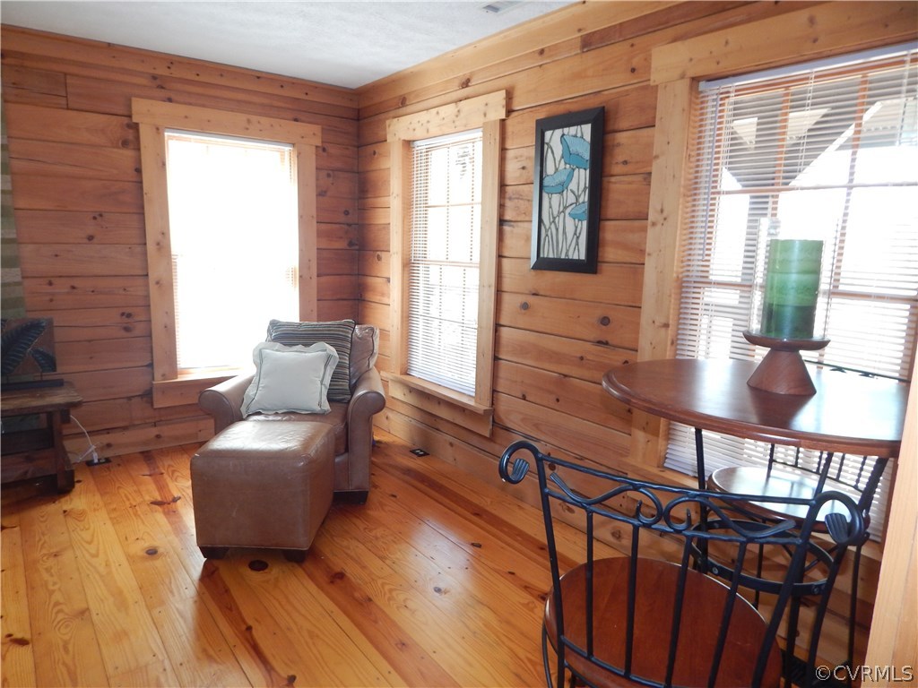 1451 Mill Road Henrico, VA 23231 - Photo 9 of 23 a living room with furniture floor to ceiling window and wooden floor