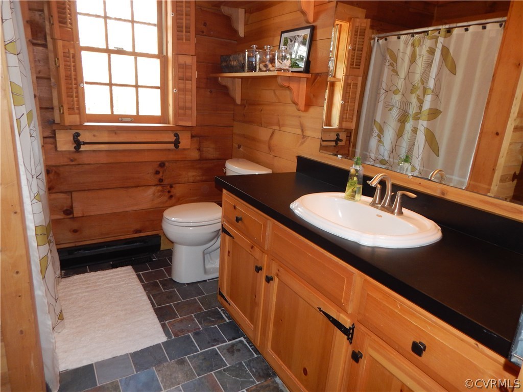 1451 Mill Road Henrico, VA 23231 - Photo 10 of 23 a bathroom with a sink a toilet and shower curtain