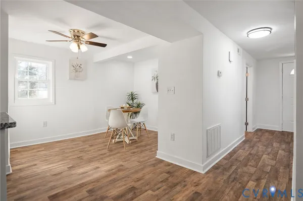 wooden floor in an empty room with a window