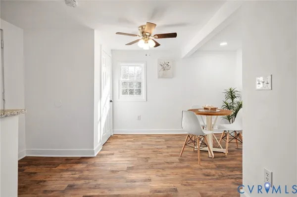 a view of a dining room with furniture and a chandelier fan