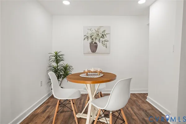 a view of a dining room with furniture and wooden floor