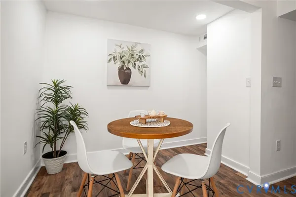a dining room with furniture and wooden floor