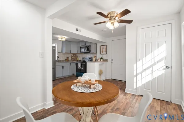 a view of a dining room with furniture and wooden floor