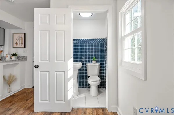 a bathroom with a toilet and a window