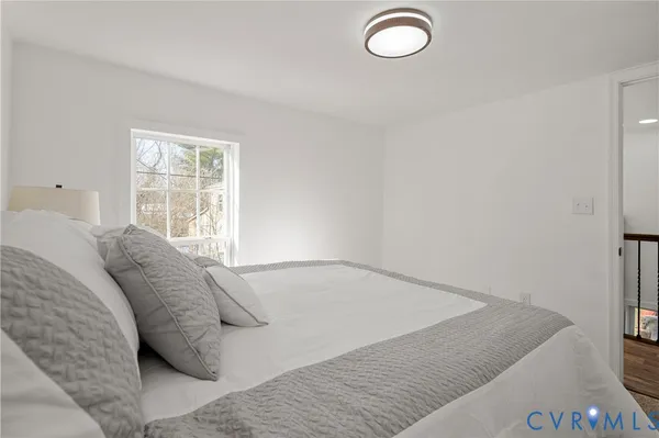 a bed sitting in a bedroom next to a window