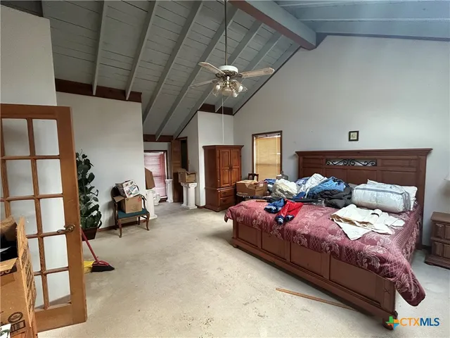 a bedroom with bed and a window