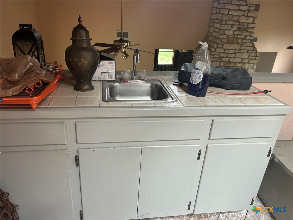 3849 Zion Hill Road Seguin, TX 78155 - Photo 22 of 35 a kitchen with a sink and cabinets
