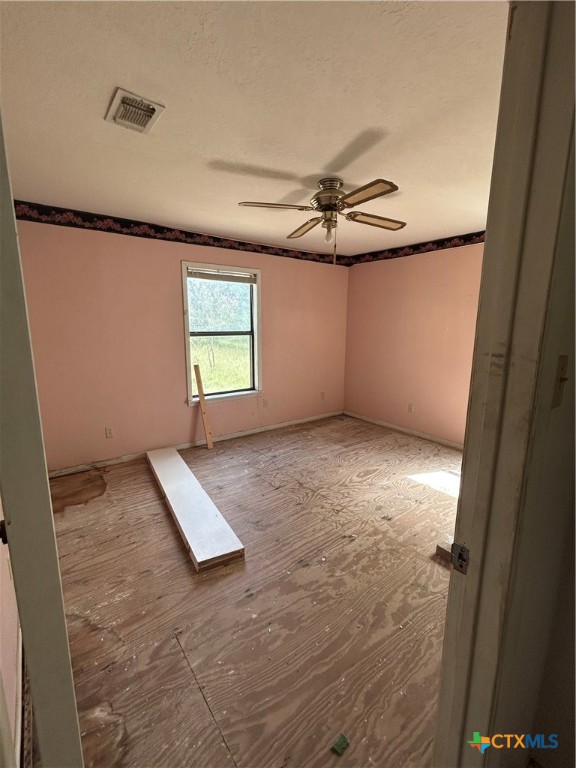 3849 Zion Hill Road Seguin, TX 78155 - Photo 30 of 35 an empty room with windows and fan