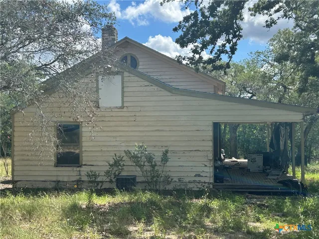 a backyard of a house with yard and outdoor seating