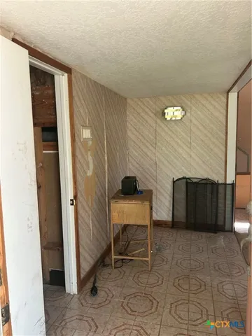 a view of a livingroom with furniture and a window