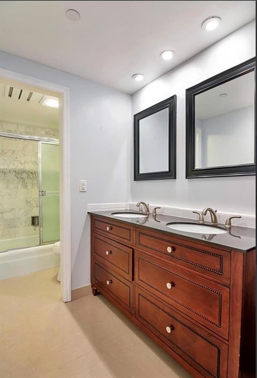 859 Jeffery Street, Unit 214 Boca Raton, FL 33487 - Photo 11 of 32 a bathroom with a granite countertop sink mirror and bathtub