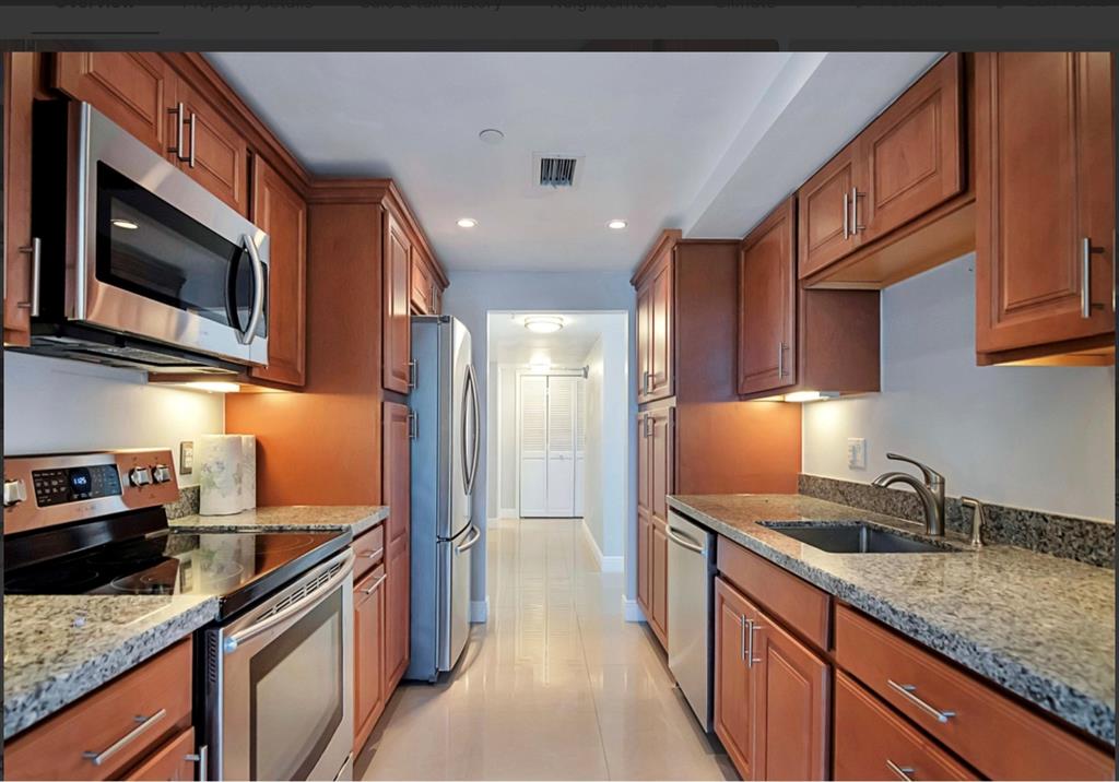 859 Jeffery Street, Unit 214 Boca Raton, FL 33487 - Photo 15 of 32 a kitchen with stainless steel appliances granite countertop a sink stove and cabinets