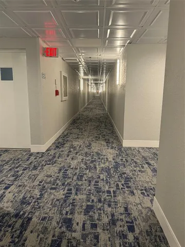 a view of a hallway with a refrigerator