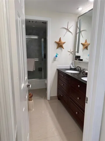 a bathroom with a sink and mirror