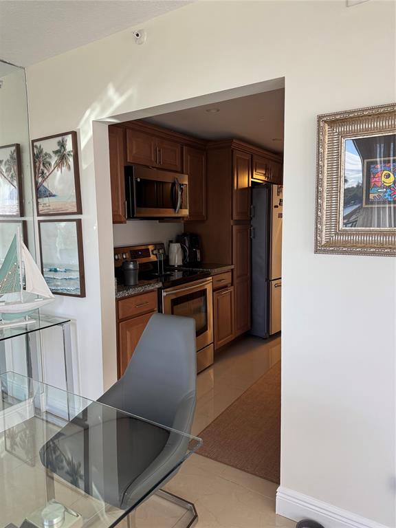 859 Jeffery Street, Unit 214 Boca Raton, FL 33487 - Photo 25 of 32 a kitchen with stainless steel appliances granite countertop a refrigerator and a stove top oven