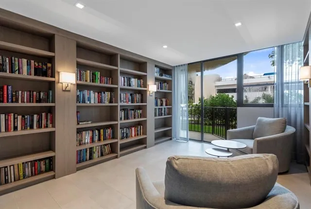 a living room with furniture and a book shelf