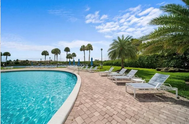 a view of swimming pool with outdoor seating and plants