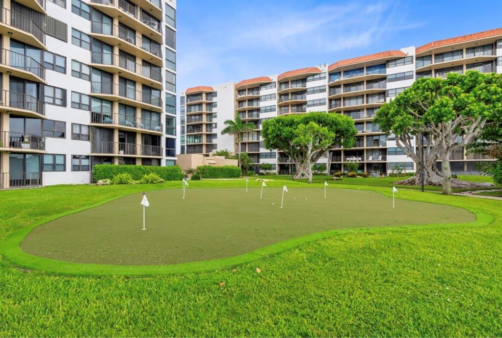 859 Jeffery Street, Unit 214 Boca Raton, FL 33487 - Photo 31 of 32 a view of building with garden and trees