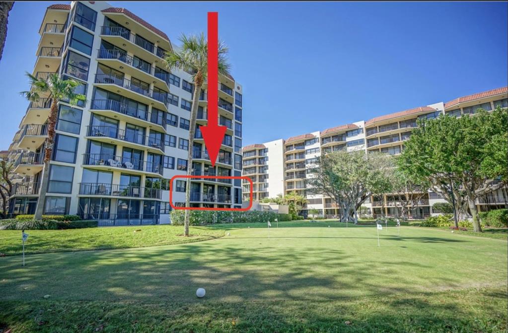 859 Jeffery Street, Unit 214 Boca Raton, FL 33487 - Photo 8 of 32 a tall building with a yard in front of it