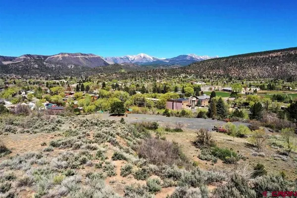 a view of a large mountain with mountains in the background