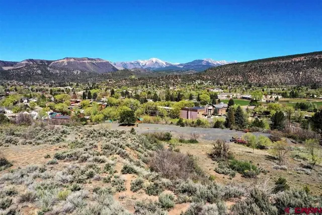 a view of a large mountain with mountains in the background