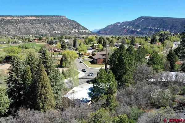 an aerial view of residential house and car parked