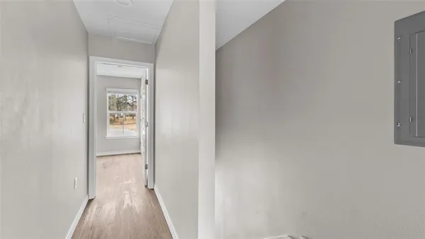 a view of a hallway with wooden floor