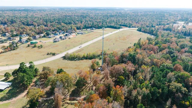 an aerial view of a houses with yard