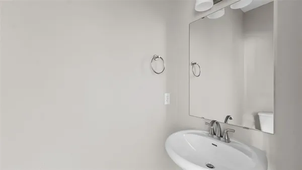 a bathroom with a sink and mirror