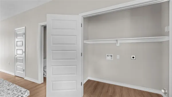 a view of walk in closet with empty racks