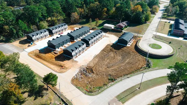 an aerial view of a house with outdoor space