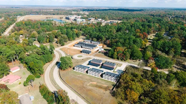 an aerial view of a house with a yard and lake view