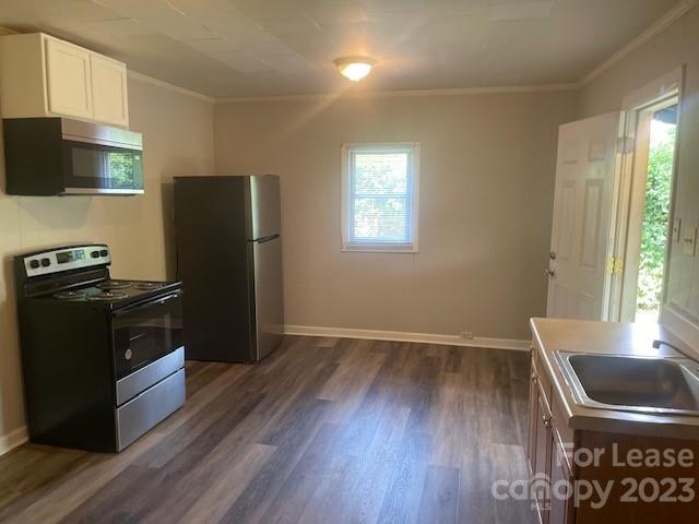320 Orange Street Charlotte, NC 28205 - Photo 13 of 14 a kitchen with a wooden floor and a refrigerator