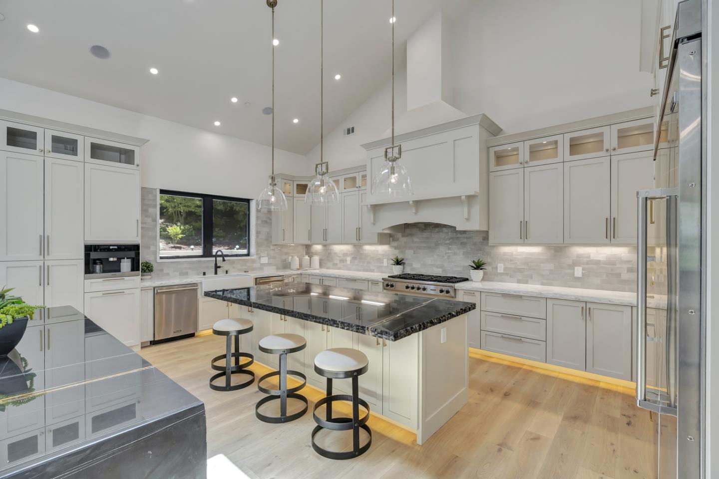 15941 Viewfield Road Monte Sereno, CA 95030 - Photo 13 of 70 a kitchen with a sink stove and white cabinets with wooden floor