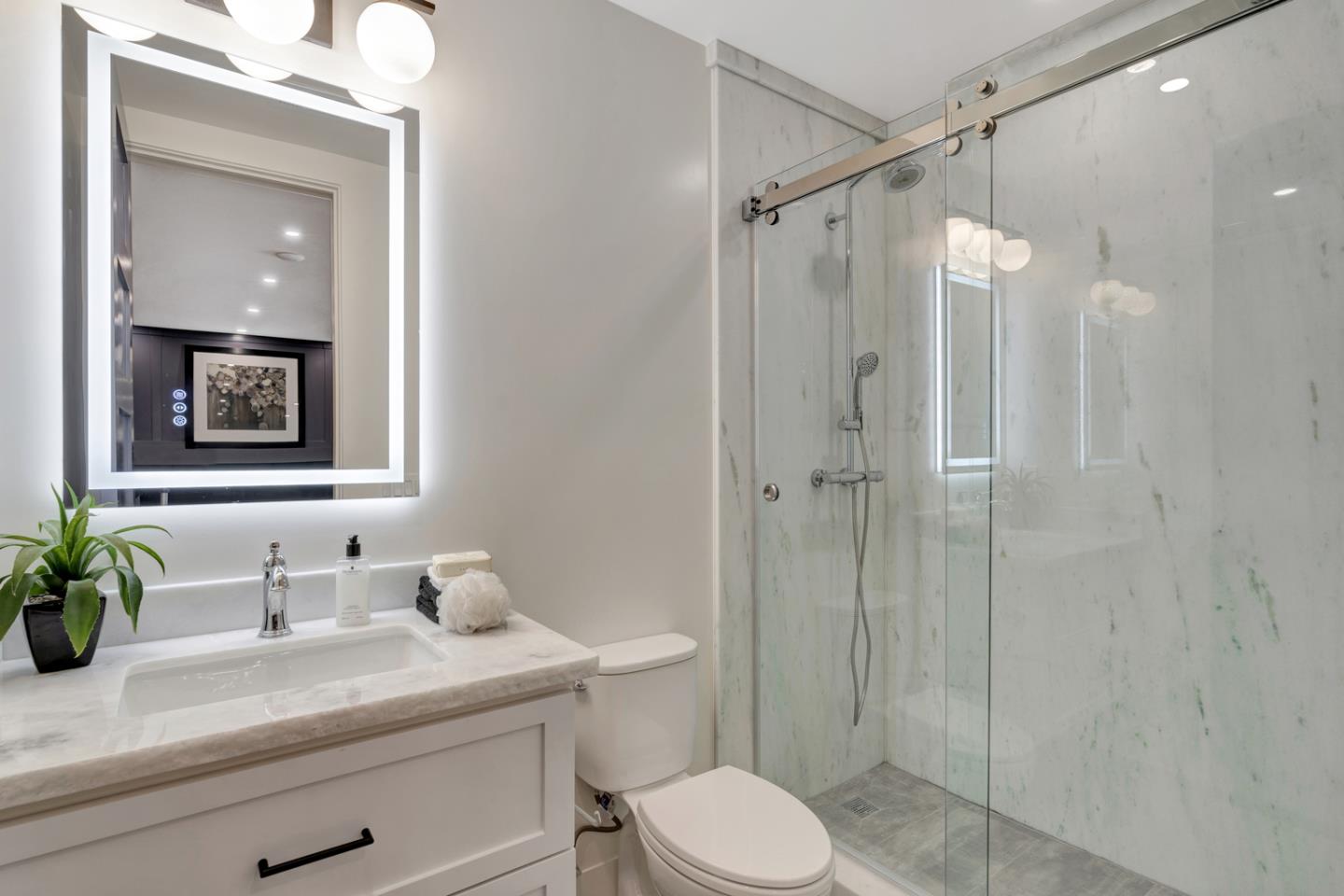 15941 Viewfield Road Monte Sereno, CA 95030 - Photo 23 of 70 a bathroom with a granite countertop sink a toilet a shower and a mirror