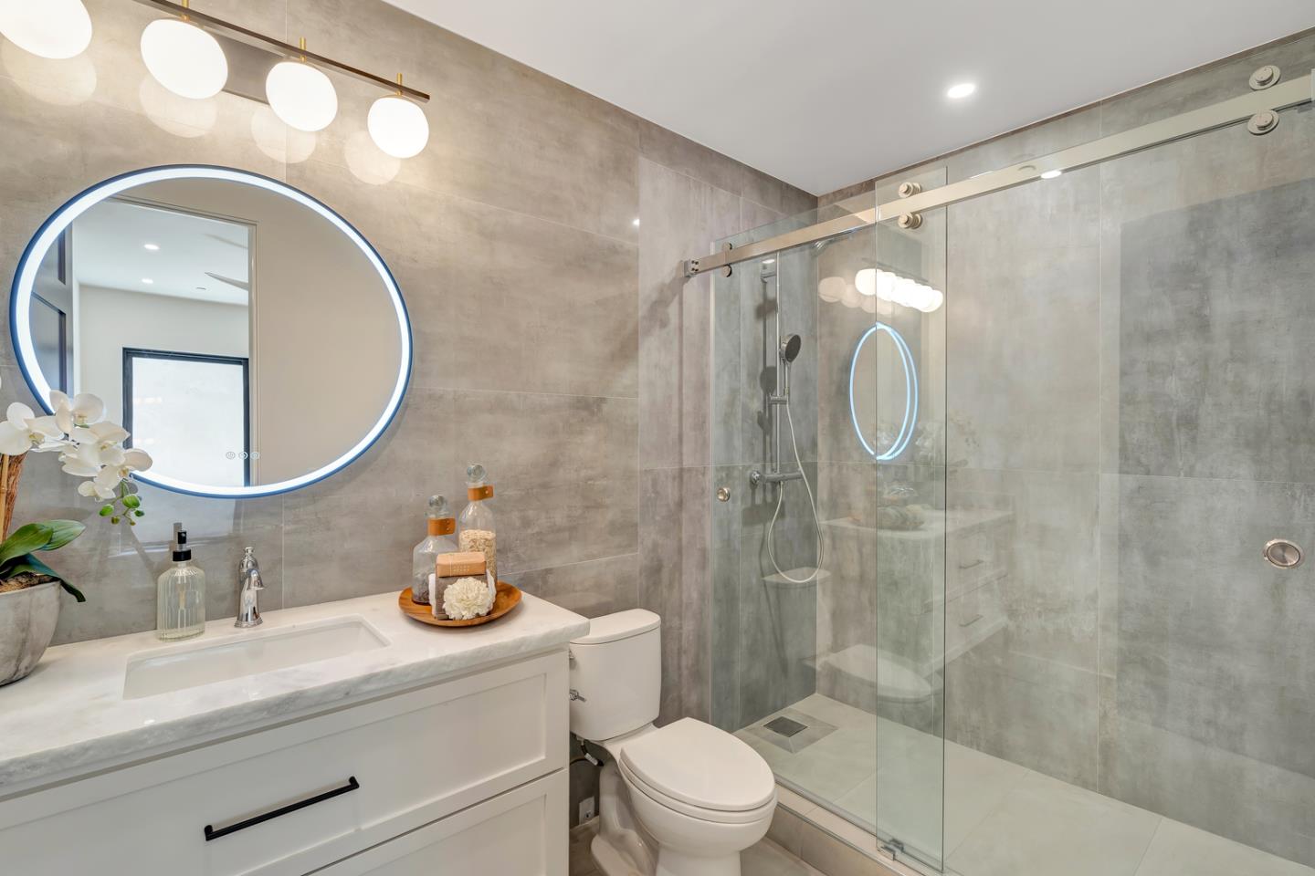 15941 Viewfield Road Monte Sereno, CA 95030 - Photo 33 of 70 a bathroom with a sink a toilet a mirror and shower