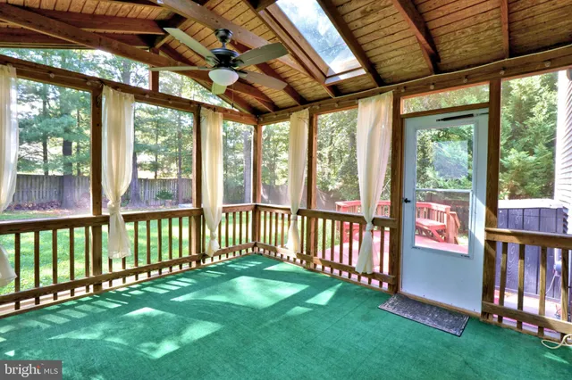 a view of a porch with furniture and garden