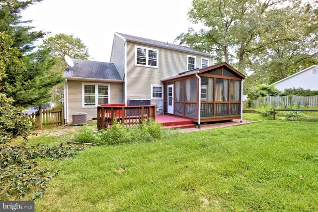 a view of backyard of house with green space
