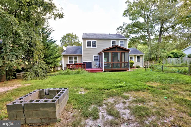 a front view of a house with a yard table and chairs
